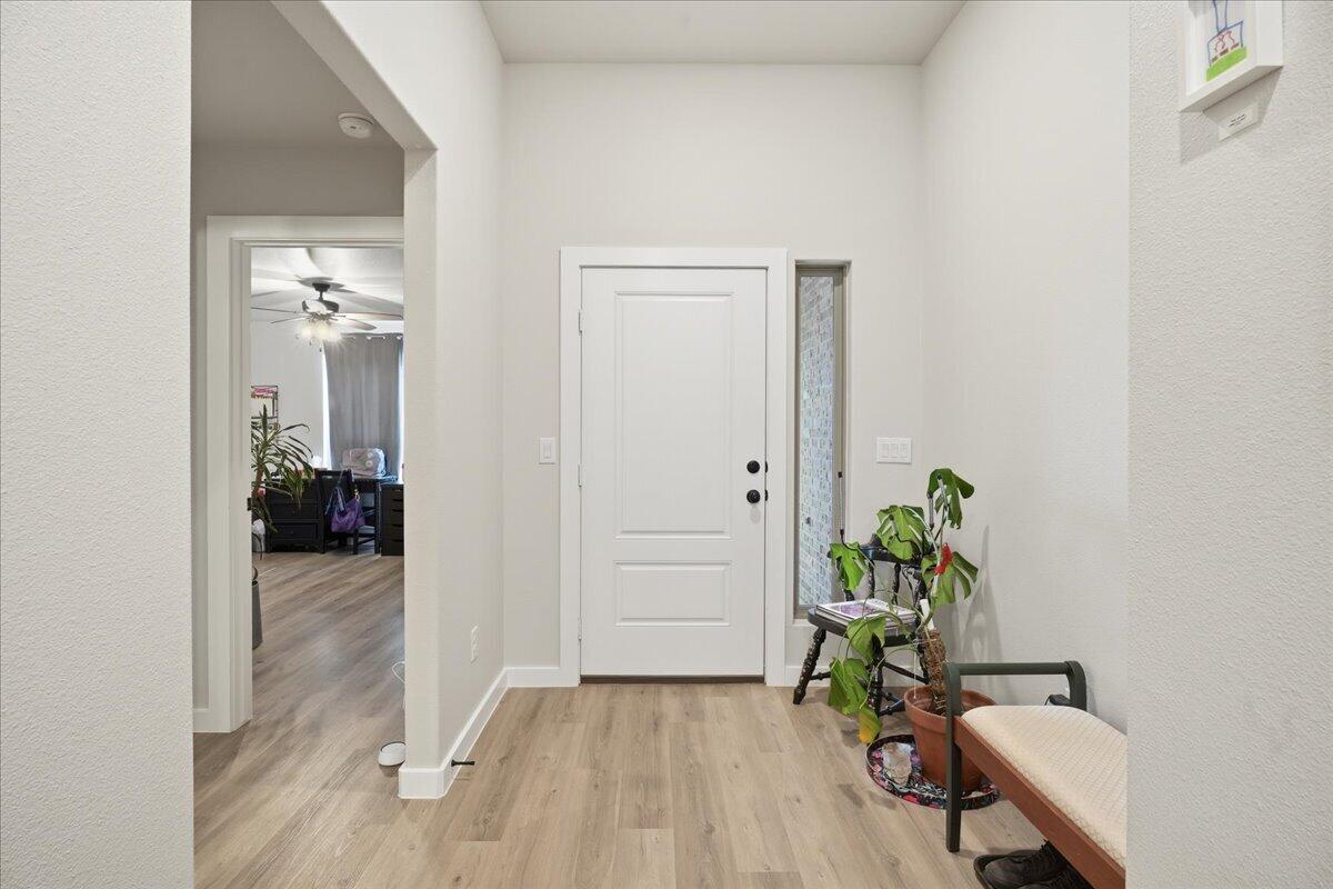 7416 30th Street Lubbock, TX 79407 - Photo 4 of 31 view of a hallway with wooden floor and a livingroom
