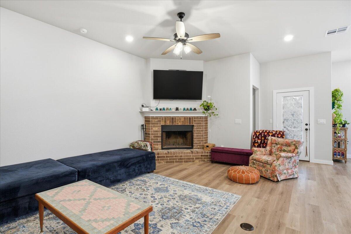 7416 30th Street Lubbock, TX 79407 - Photo 6 of 31 a living room with furniture and a fireplace