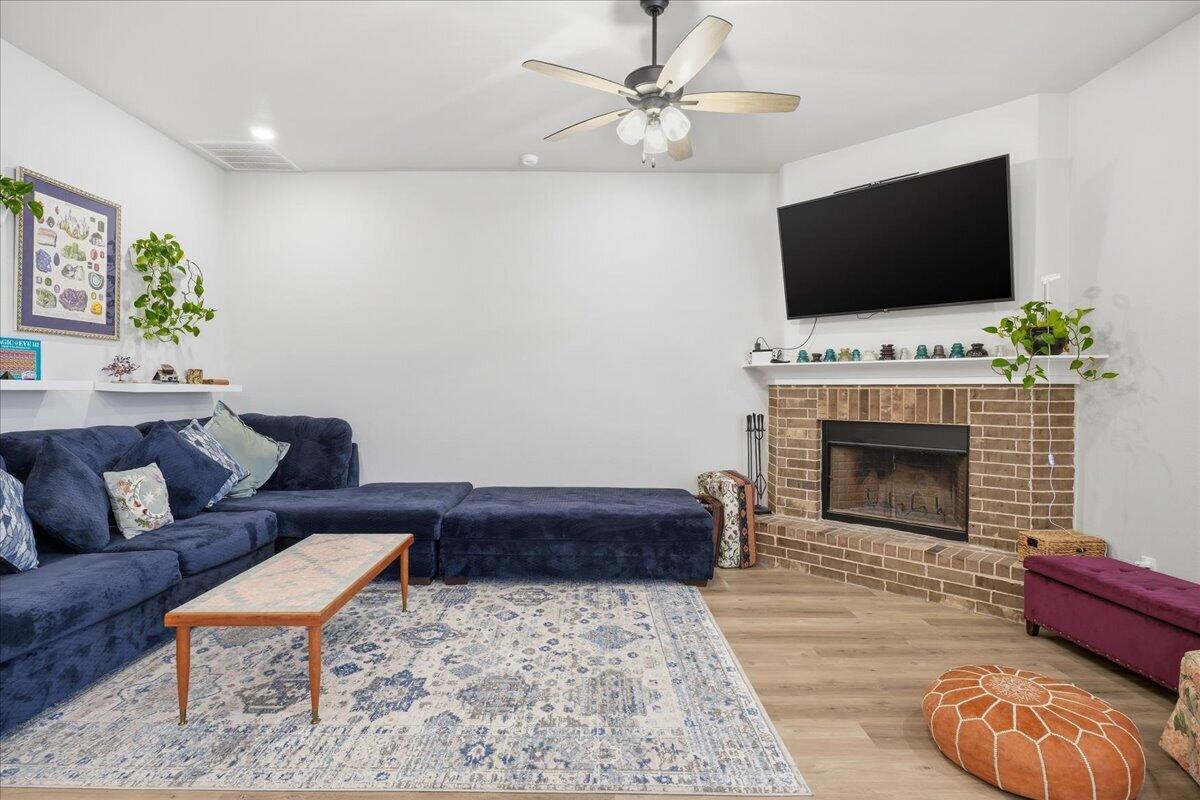 7416 30th Street Lubbock, TX 79407 - Photo 7 of 31 a living room with furniture and a flat screen tv