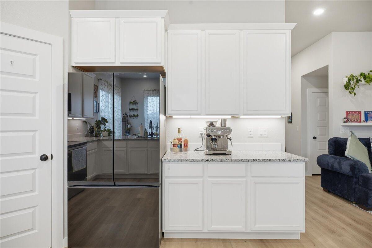 7416 30th Street Lubbock, TX 79407 - Photo 10 of 31 a kitchen with granite countertop cabinets and appliances