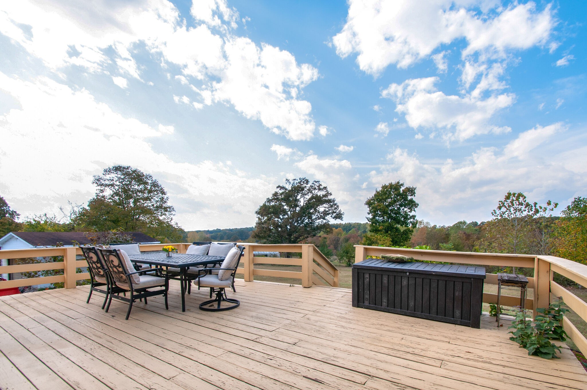 7690 Barnhill Road Primm Springs, TN 38476 - Photo 37 of 50 a roof deck with table and chairs and wooden floor