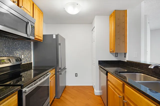 a kitchen with a sink stove and refrigerator