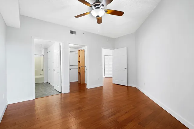 a view of an empty room with a ceiling fan