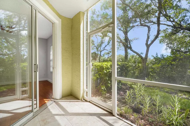 a porch with a glass door and shower