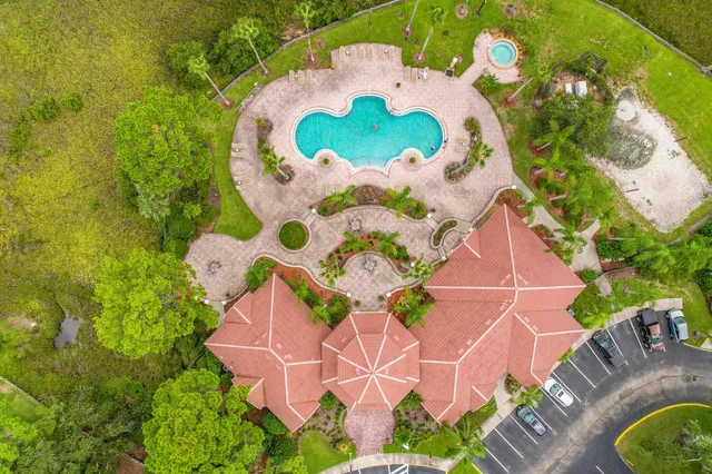 an aerial view of a house with a swimming pool and garden