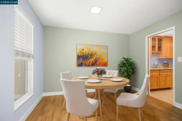 a dining room with furniture and wooden floor