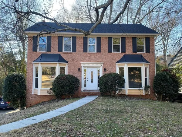 a front view of a house with a garden
