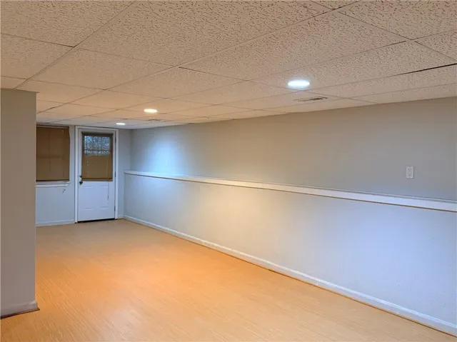 a bathroom with a granite countertop sink toilet and mirror