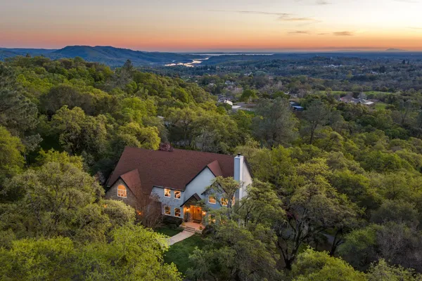 an aerial view of a house with a yard
