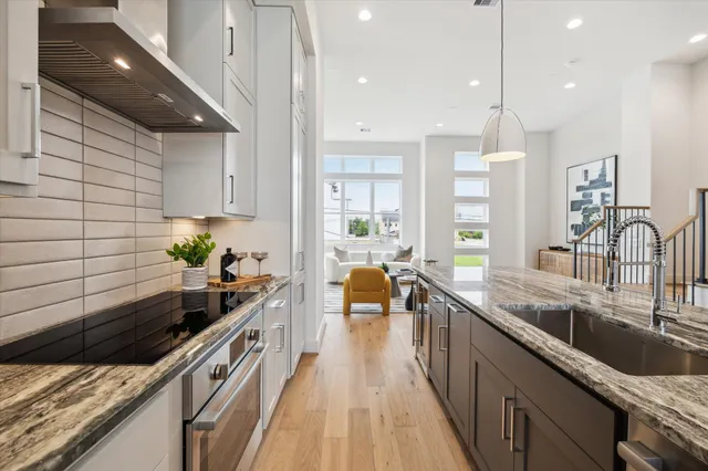 a kitchen with sink stove and cabinets