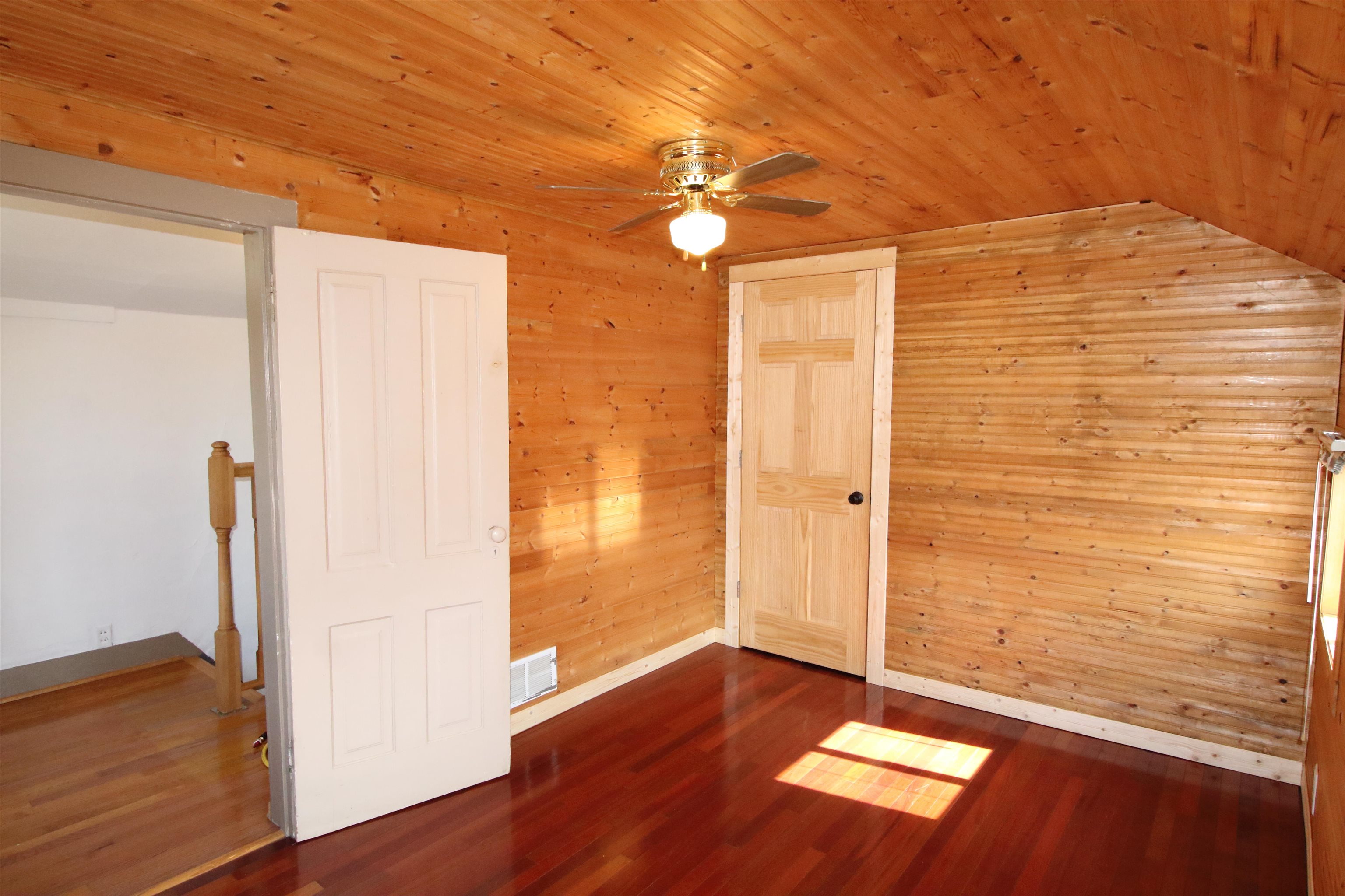 17896 Skunk Hollow Road Mount Carroll, IL 61053 - Photo 14 of 36 a view of an empty room with wooden floor and a window