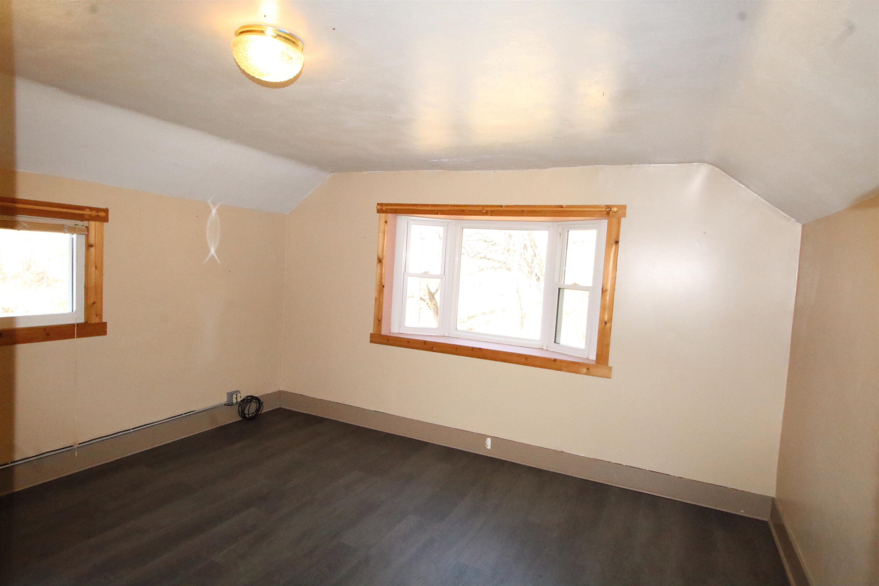 17896 Skunk Hollow Road Mount Carroll, IL 61053 - Photo 8 of 36 an empty room with wooden floor and windows