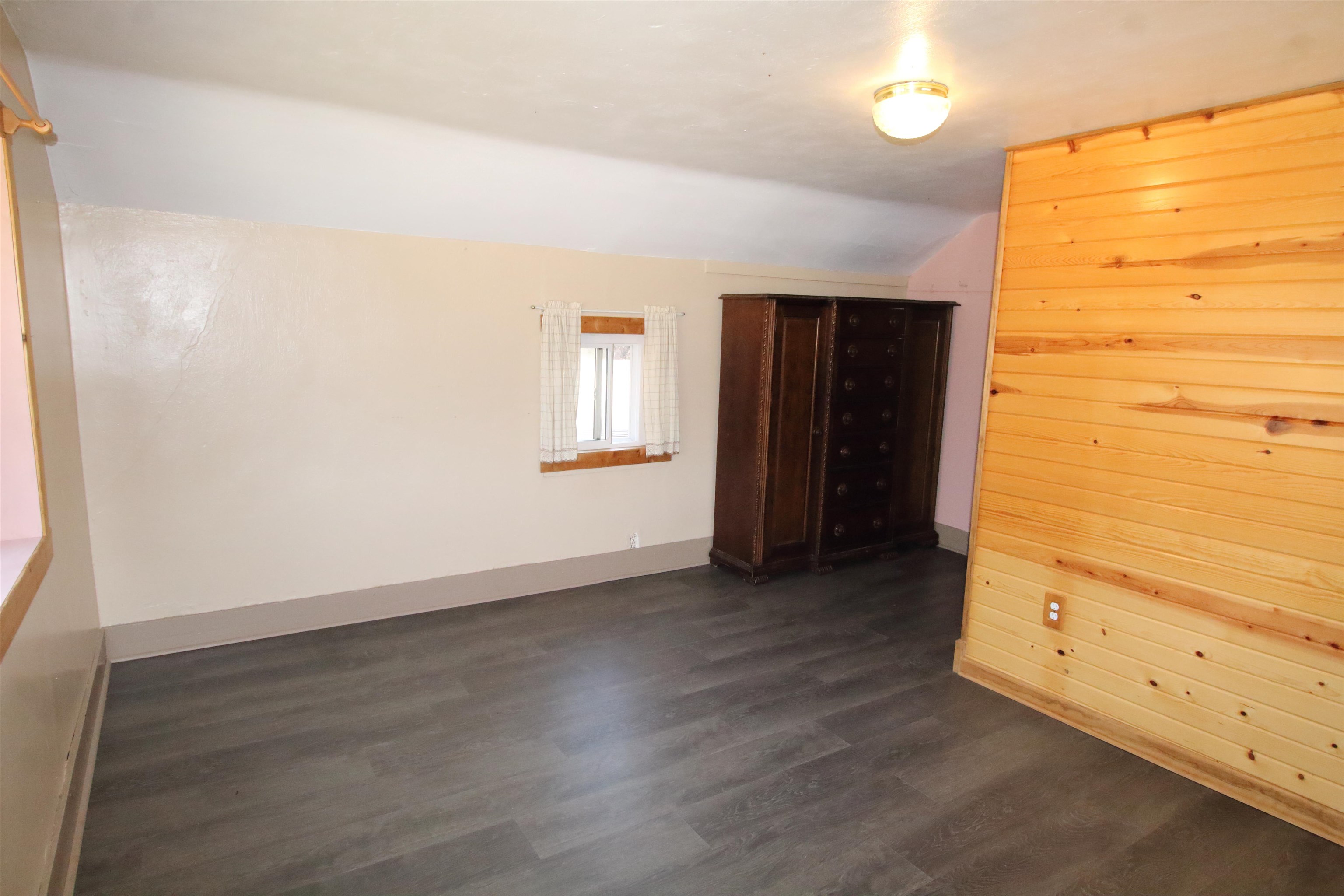 17896 Skunk Hollow Road Mount Carroll, IL 61053 - Photo 9 of 36 an empty room with wooden floor and windows