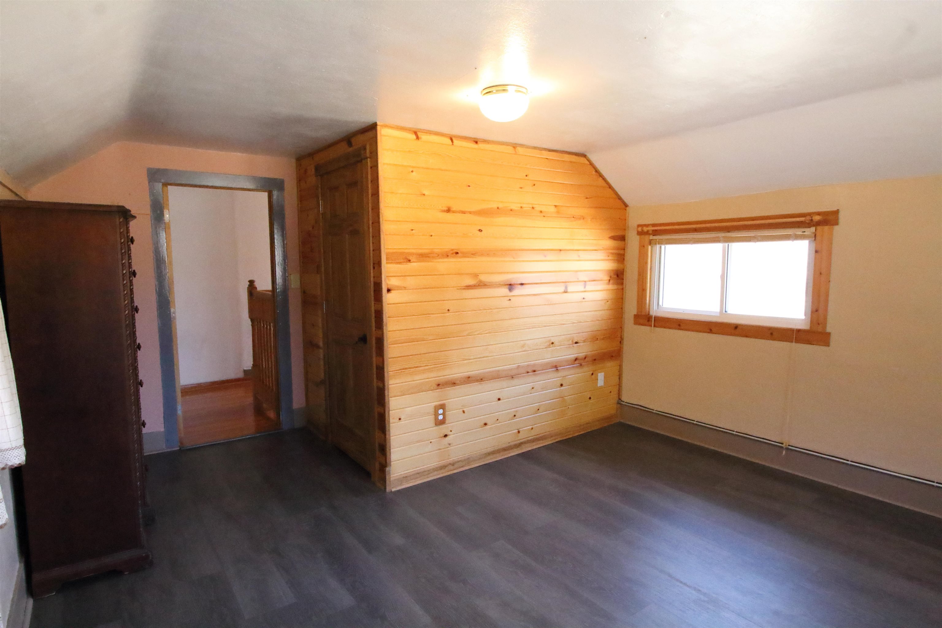 17896 Skunk Hollow Road Mount Carroll, IL 61053 - Photo 10 of 36 an empty room with wooden floor and a window