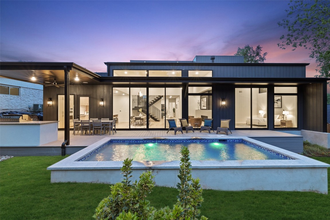 a view of a house with swimming pool patio and outdoor seating