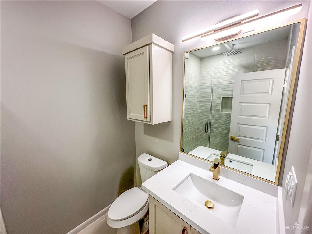 2002 East 1st Street, Unit 2 Mission, TX 78572 - Photo 12 of 15 Full bath featuring vanity and a stall shower