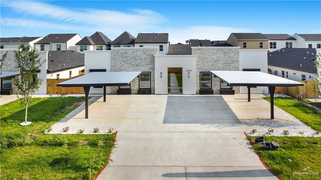 2002 East 1st Street, Unit 2 Mission, TX 78572 - Photo 2 of 15 View of front of home with stone siding, a residential view, and stucco siding