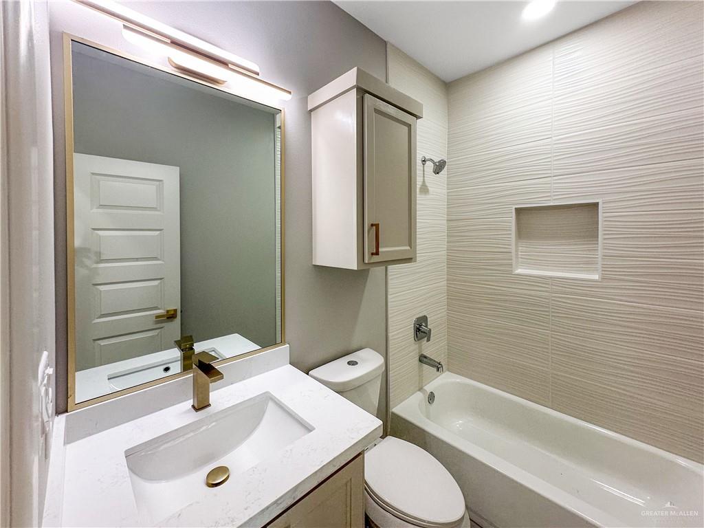 2002 East 1st Street, Unit 2 Mission, TX 78572 - Photo 8 of 15 Bathroom featuring vanity and washtub / shower combination