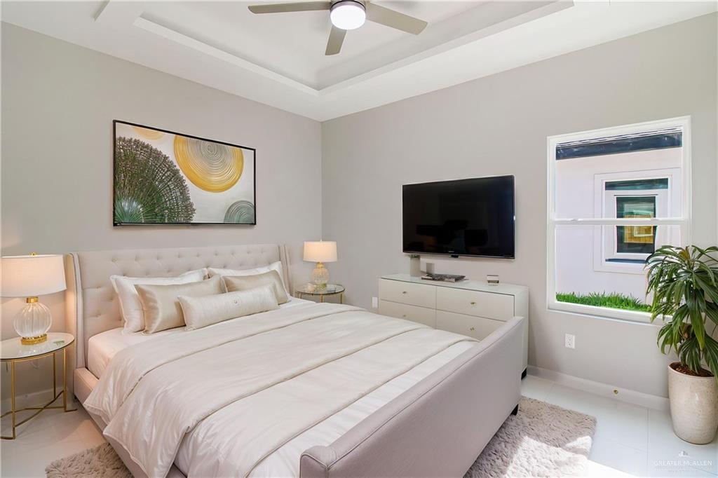 2002 East 1st Street, Unit 2 Mission, TX 78572 - Photo 10 of 15 Bedroom with a raised ceiling and a ceiling fan-property is virtually staged