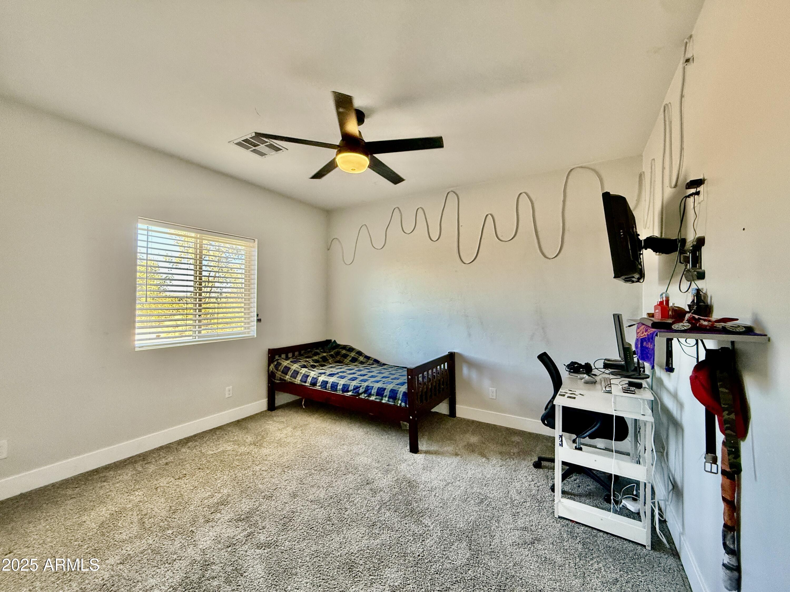 640 South 600 West Pima, AZ 85543 - Photo 15 of 22 a bedroom with furniture and a window