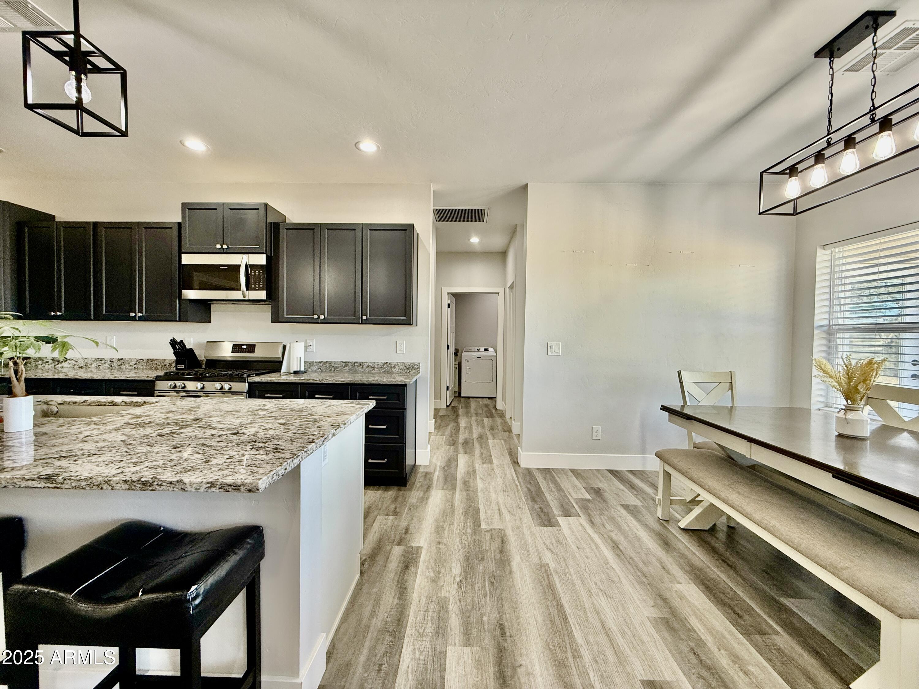 640 South 600 West Pima, AZ 85543 - Photo 2 of 22 a kitchen with stainless steel appliances granite countertop a stove refrigerator sink and cabinets
