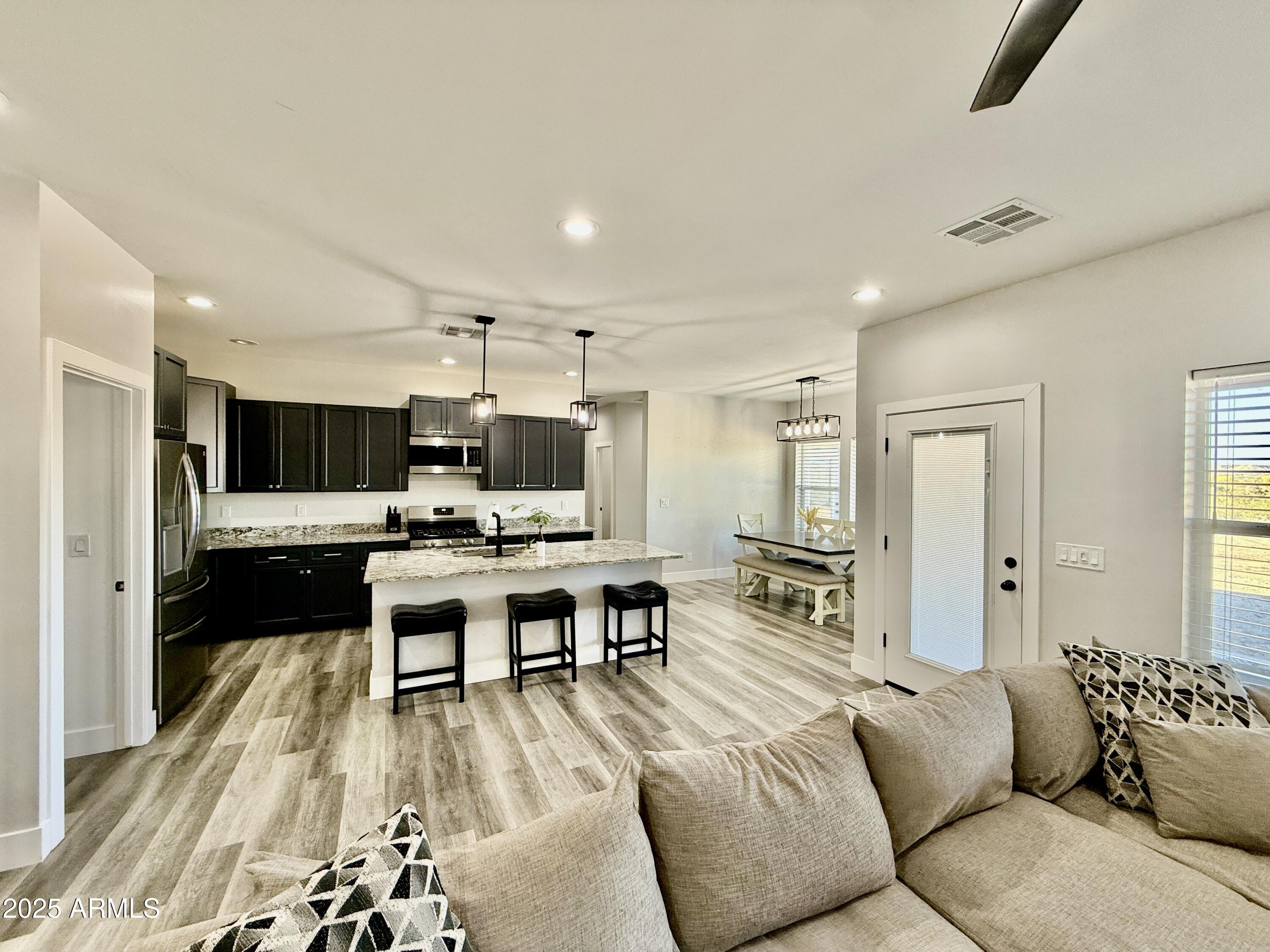 640 South 600 West Pima, AZ 85543 - Photo 4 of 22 a living room with furniture kitchen view and a flat screen tv