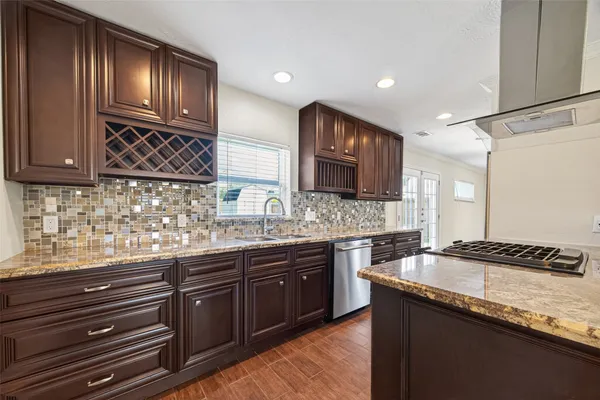 a kitchen with granite countertop stainless steel appliances and wooden cabinets