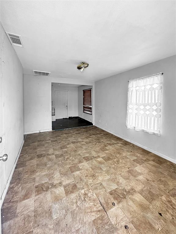 535 Ella Avenue Dallas, TX 75217 - Photo 2 of 8 a view of an empty room with a window