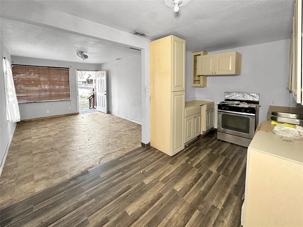 535 Ella Avenue Dallas, TX 75217 - Photo 4 of 8 a view of a kitchen with a sink stove refrigerator and cabinets