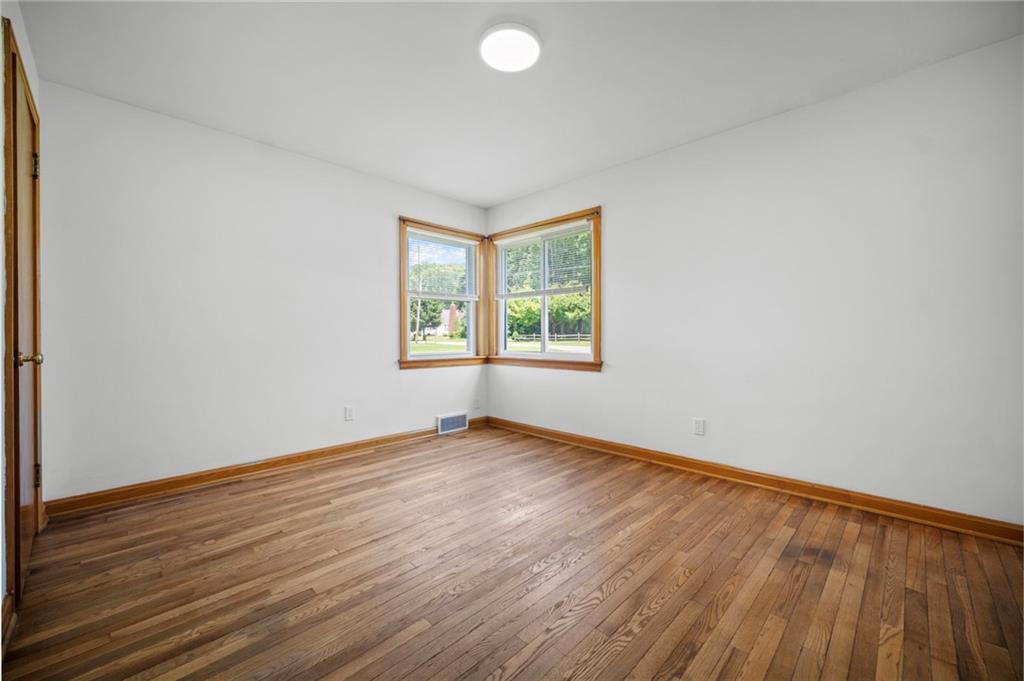 389 Mercer Road Greenville, PA 16125 - Photo 22 of 38 an empty room with wooden floor and windows