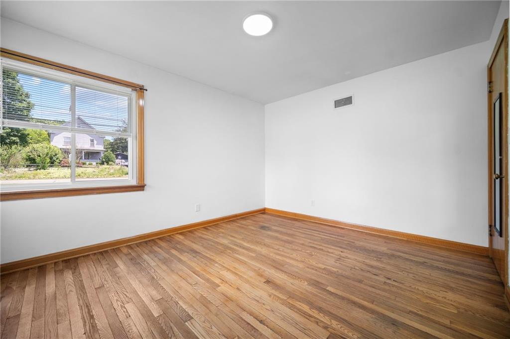 389 Mercer Road Greenville, PA 16125 - Photo 23 of 38 a view of an empty room with wooden floor and a window