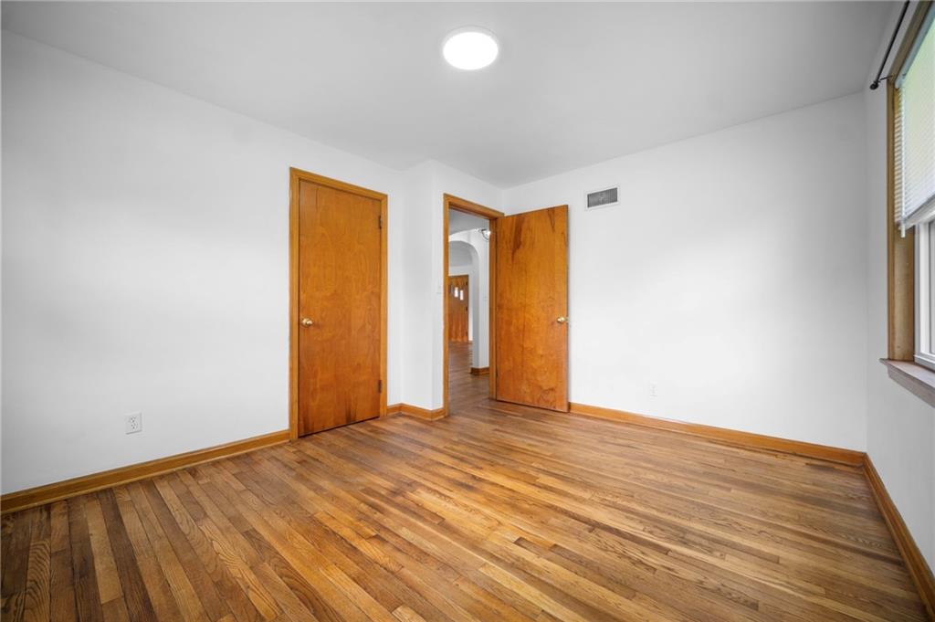 389 Mercer Road Greenville, PA 16125 - Photo 26 of 38 a view of an empty room with wooden floor and a window