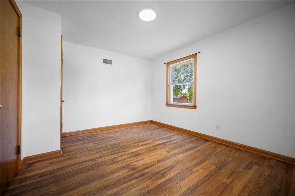 389 Mercer Road Greenville, PA 16125 - Photo 28 of 38 an empty room with wooden floor and windows