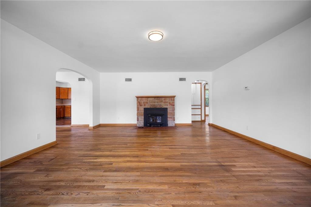 389 Mercer Road Greenville, PA 16125 - Photo 5 of 38 a view of empty room with wooden floor and fireplace