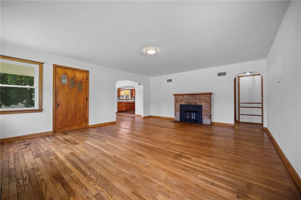 389 Mercer Road Greenville, PA 16125 - Photo 6 of 38 a view of empty room with wooden floor and fireplace