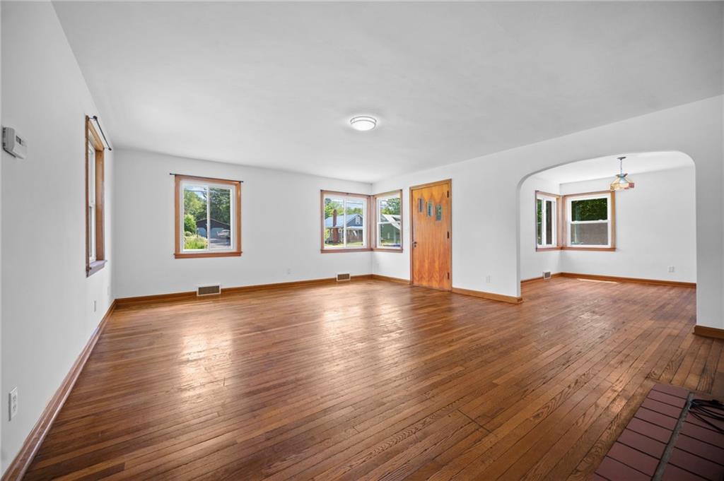 389 Mercer Road Greenville, PA 16125 - Photo 8 of 38 a view of an empty room with window and wooden floor
