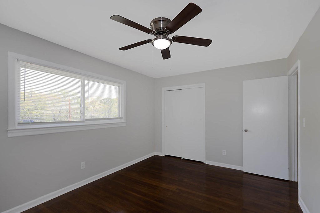 4270 Athens Court Columbus, GA 31907 - Photo 18 of 32 a view of an empty room with wooden floor and a ceiling fan
