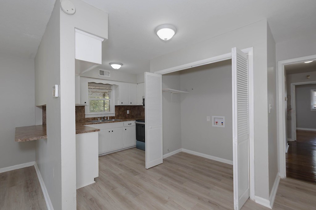 4270 Athens Court Columbus, GA 31907 - Photo 26 of 32 a kitchen with white cabinets and wooden floor