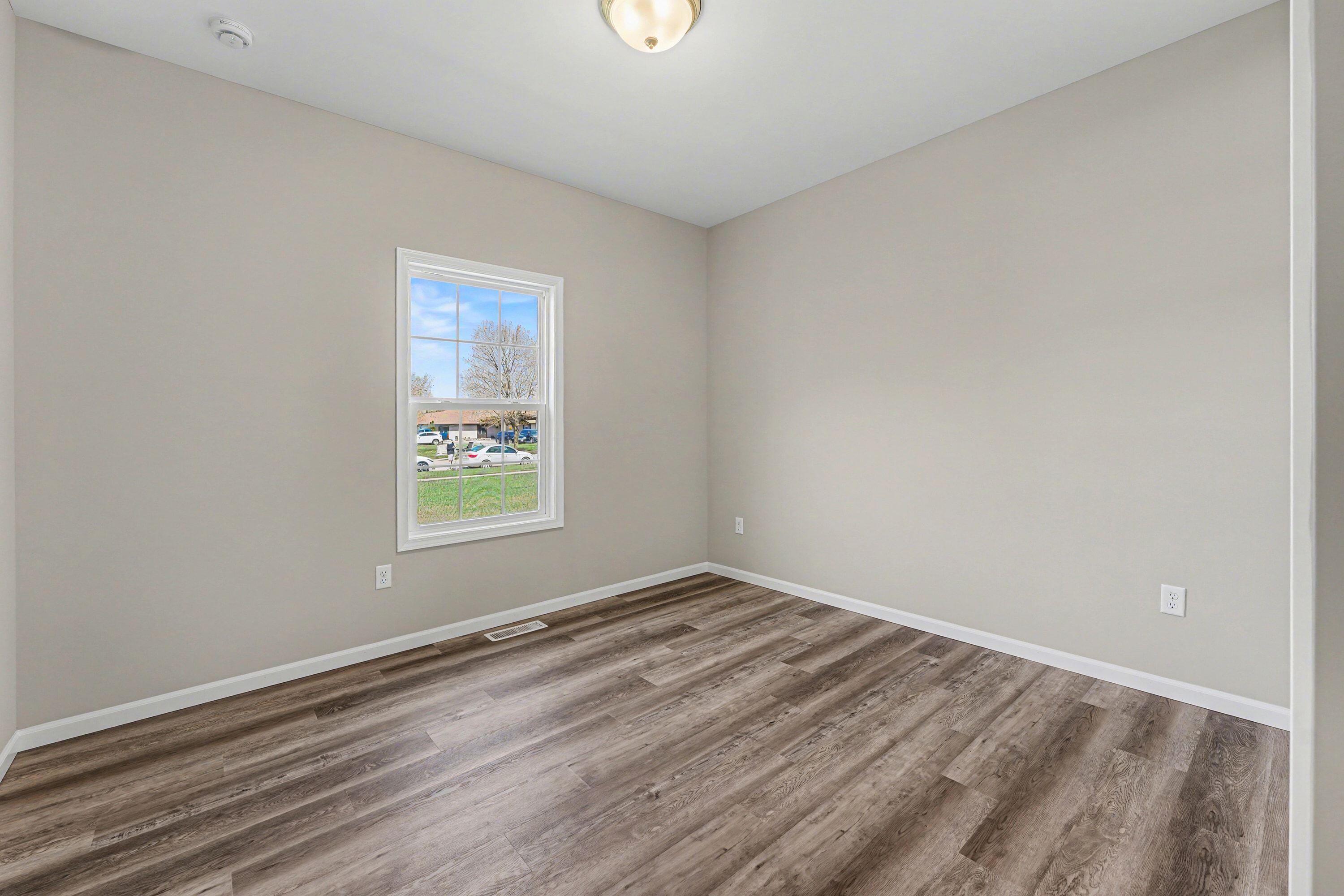 6065 Robbins Road Portage, IN 46368 - Photo 11 of 15 wooden floor in an empty room with a window