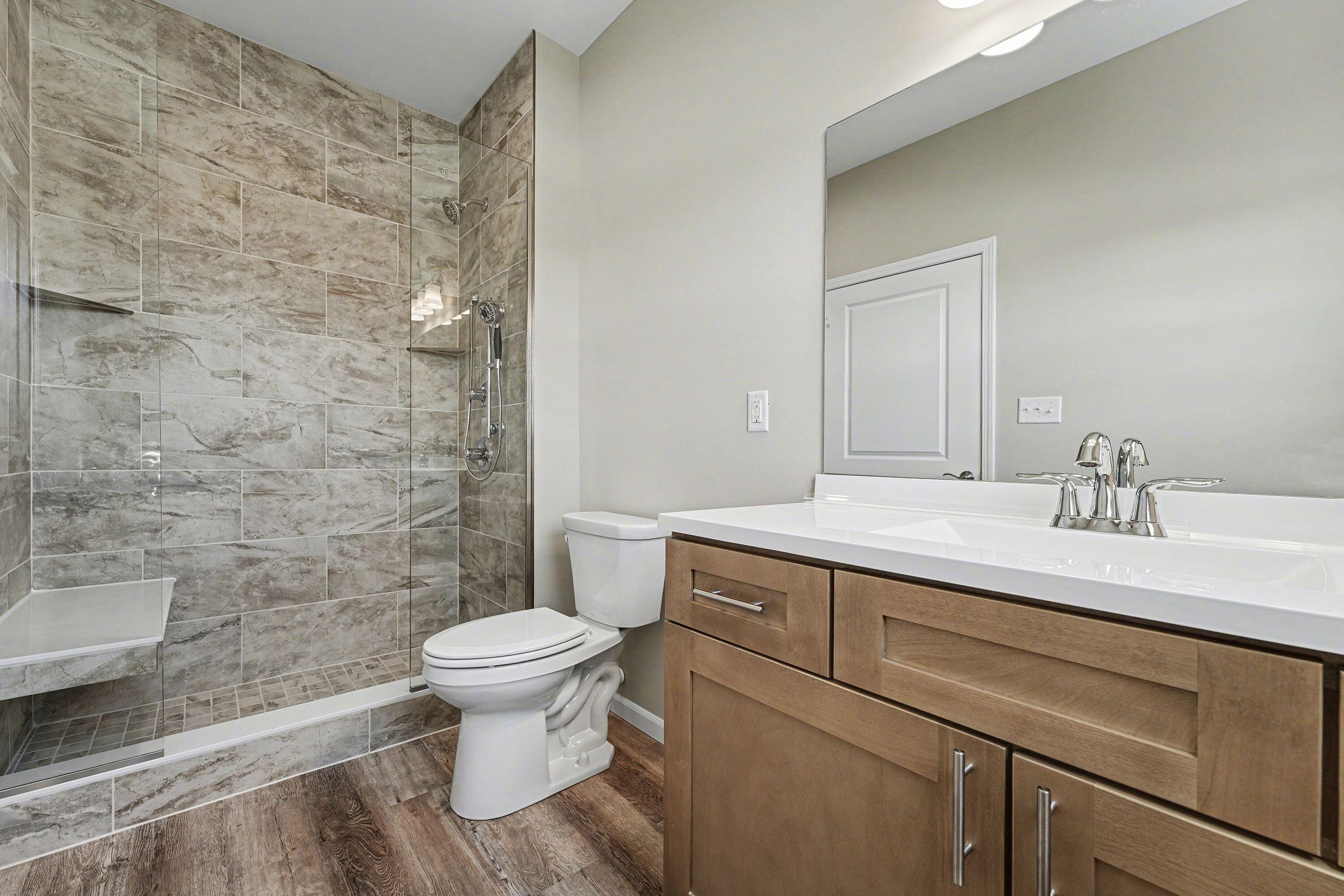 6065 Robbins Road Portage, IN 46368 - Photo 9 of 15 a bathroom with a sink a toilet a mirror and shower
