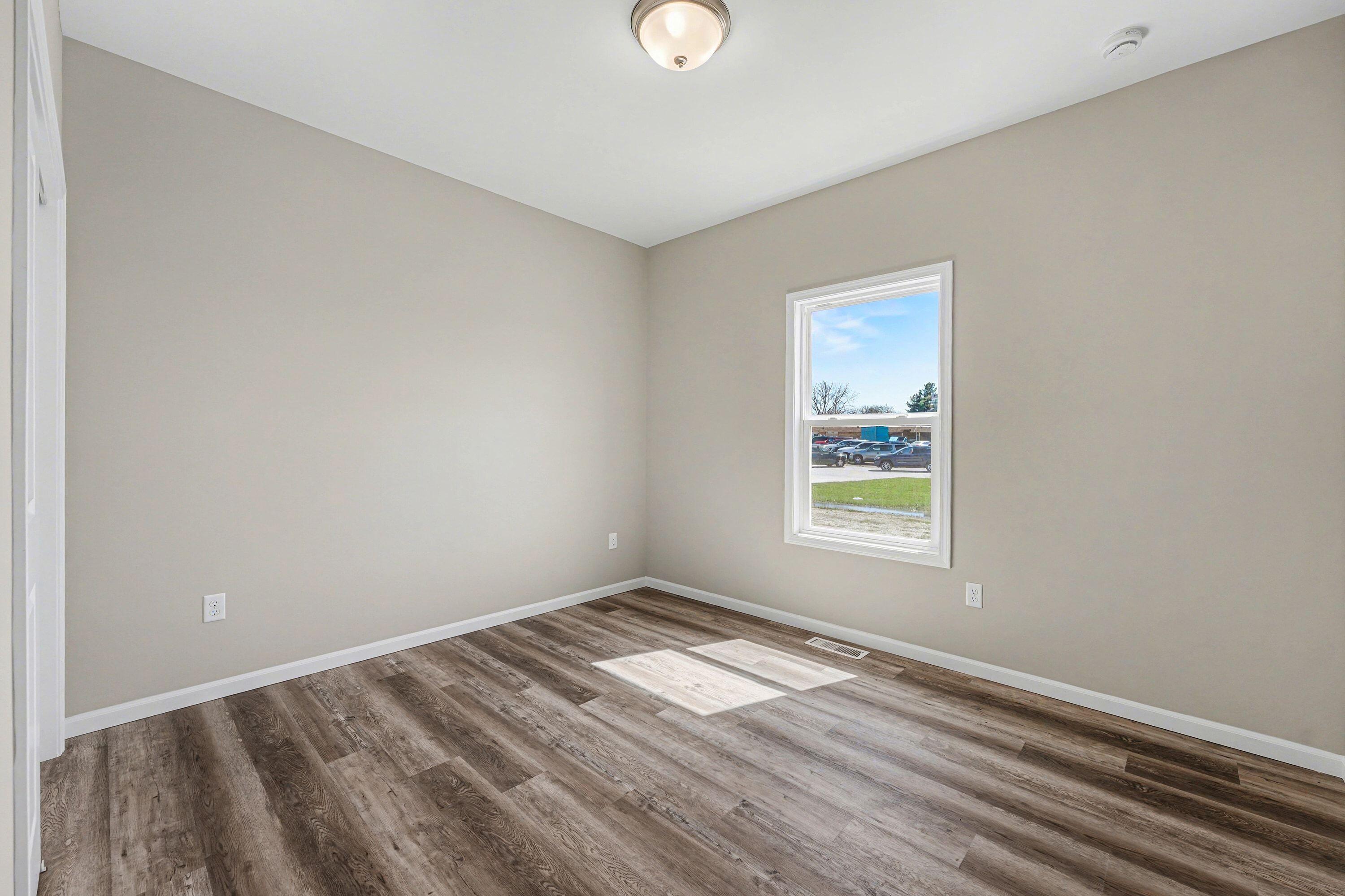 6065 Robbins Road Portage, IN 46368 - Photo 10 of 15 a view of empty room with wooden floor and fan