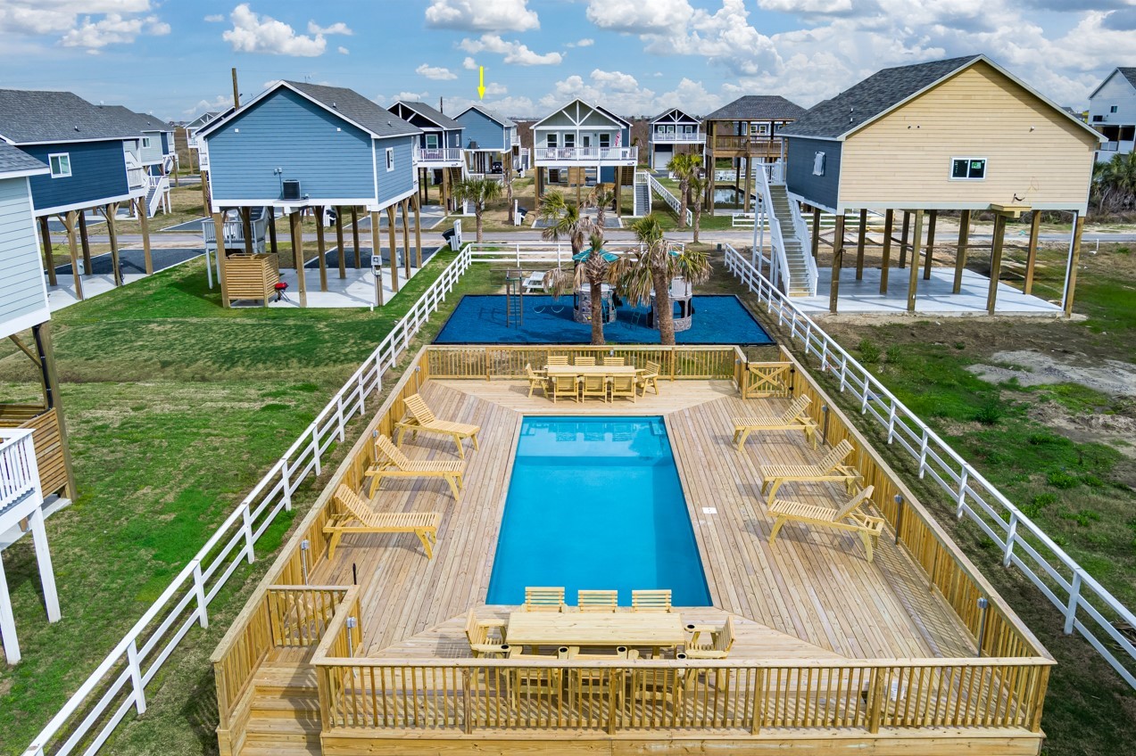 1057 Johnson Road Port Bolivar, TX 77650 - Photo 1 of 40 Days at home can easily include a refreshing swim at the neighborhood pool, with generous deck space for lounging and gathering.