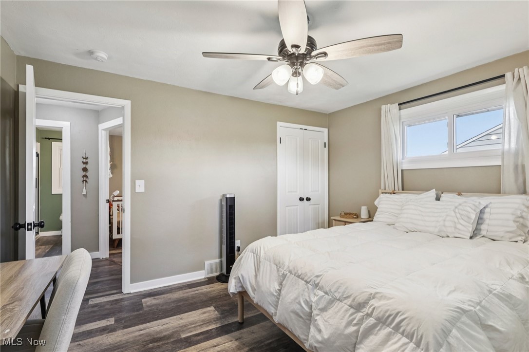 6147 Stone Road Medina, OH 44256 - Photo 22 of 40 Bedroom with dark wood-style floors, a closet, and ceiling fan