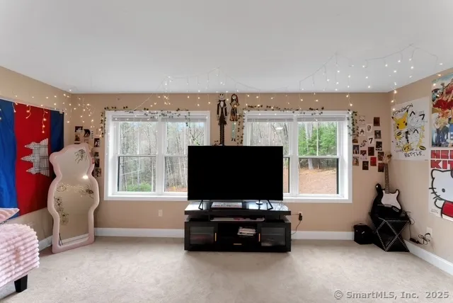 a bedroom with furniture and a flat screen tv