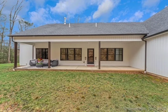 a view of a house with backyard sitting area and porch