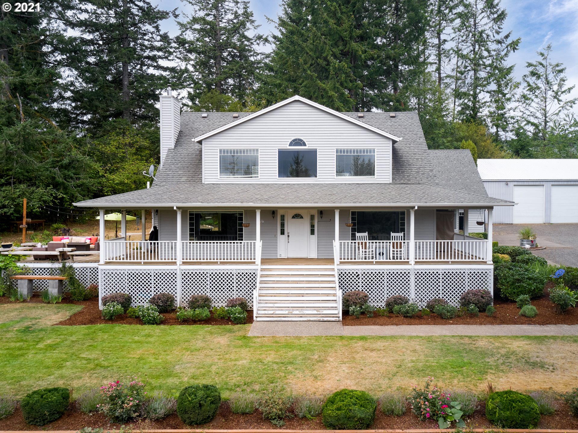 24355 Southwest Melott Road Hillsboro, OR 97123 - Photo 1 of 32 a front view of a house with a garden and plants