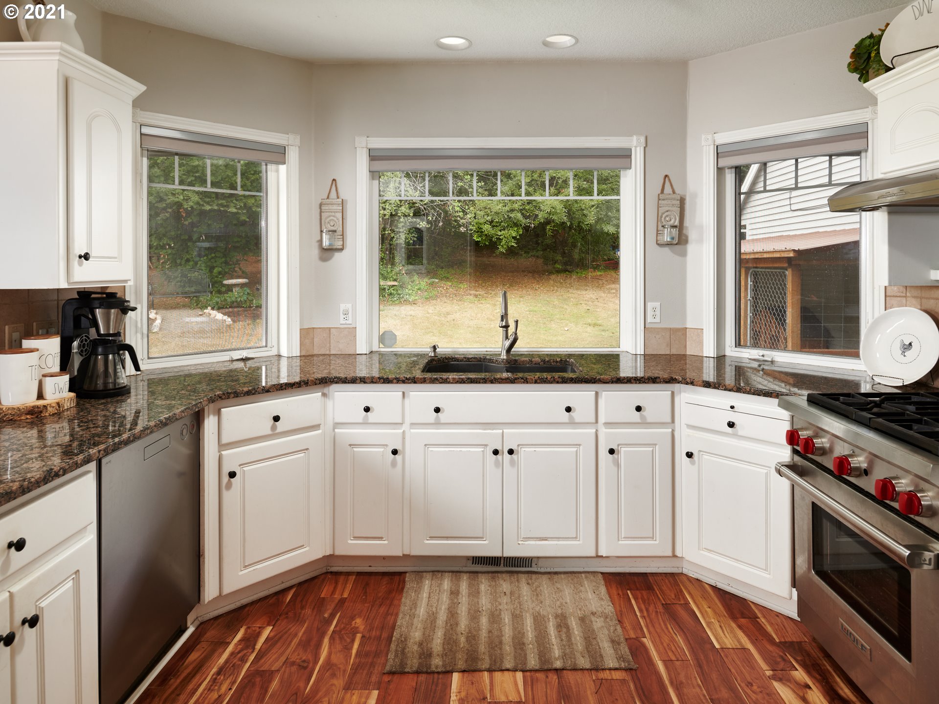 24355 Southwest Melott Road Hillsboro, OR 97123 - Photo 15 of 32 a kitchen with granite countertop a sink and a stove next to a window