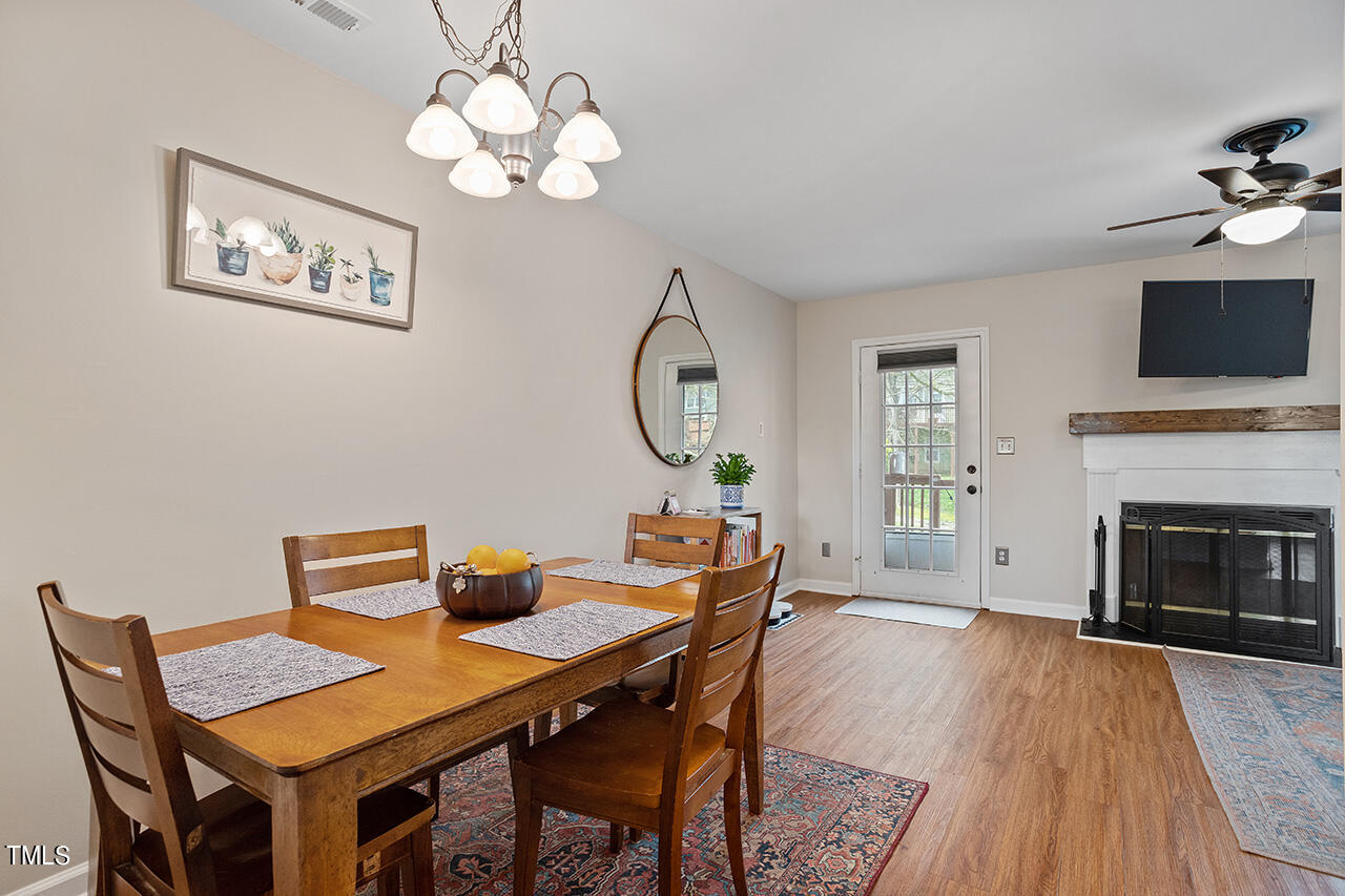 107 Long Shadow Place Durham, NC 27713 - Photo 12 of 31 a dining room with furniture a chandelier and wooden floor