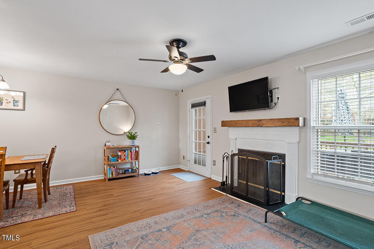 107 Long Shadow Place Durham, NC 27713 - Photo 17 of 31 a view of a livingroom with a fireplace a chandelier and wooden floor