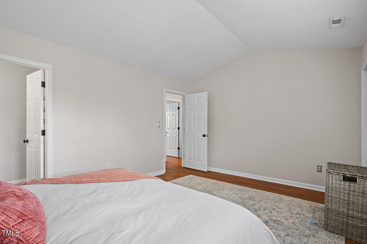 107 Long Shadow Place Durham, NC 27713 - Photo 24 of 31 a bedroom with a bed and a dresser